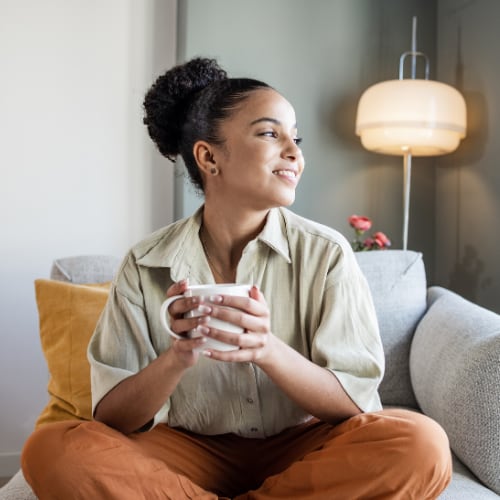 woman relaxing at home with a cup of tea