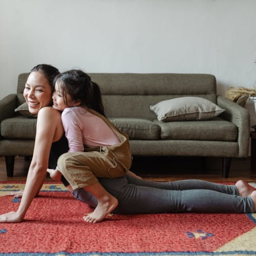 mother playing with her daughter in home living room
