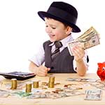 young boy in suit holding money