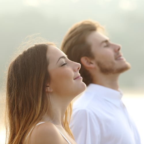 a young couple breathing outside