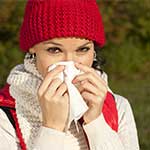 Young Woman Blowing Nose